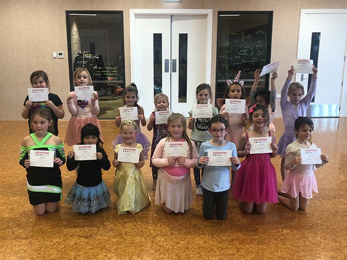 Jitterbugs dance girls with certificates
